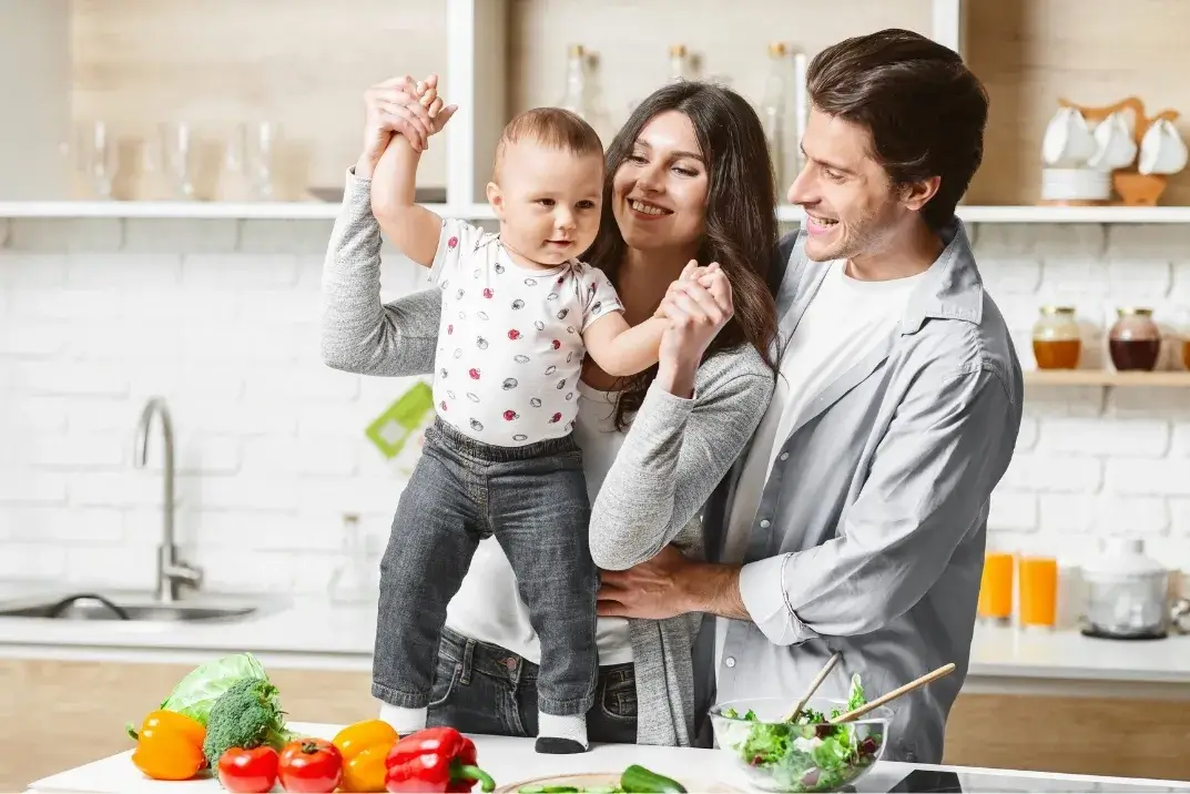 Happy family in a clean kitchen after professional home cleaning services by Diamond Maids Cleaning in Massachusetts